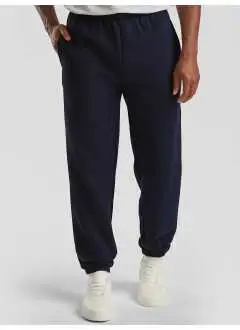 70% coton, 30% polyester. Pantalon élastique à la cheville, taille élastiquée, 2 poches latérales. (Col. 94: 260 gm²).