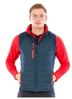 100% polyester recyclé TOPGREEN. Veste Softshell imperméable, sans manches, poches zippées contrastées, fermeture à glissière frontale YKK avec protège-menton, col et torse rembourrés, doublure REPREVE, poignets souples, tirette noire étiquette détachable.